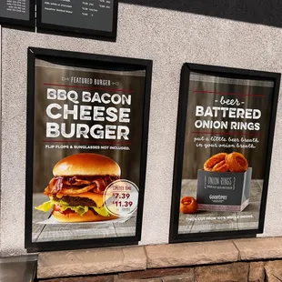 two posters on the side of a building
