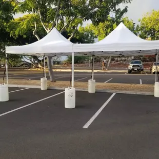 10x20 pop up with water barrels