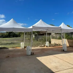 (3) 10x10 white pop ups, with water barrels.