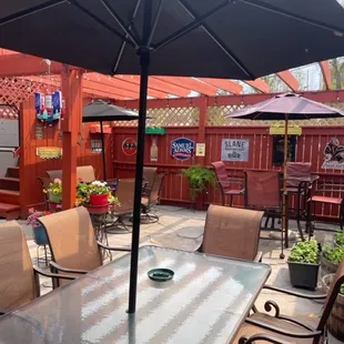 a patio with tables and chairs