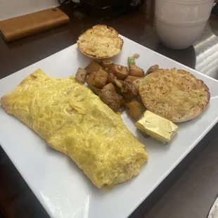 Corn beef omelette with home potatoes and English muffin. Delicious and potatoes are seasoned just right.