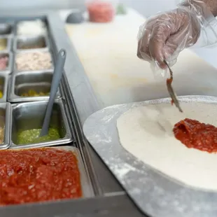 a person making a pizza