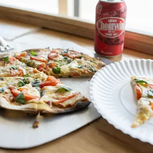 a slice of pizza and a can of soda