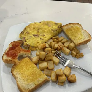 Omelet, sourdough toast with REAL butter and potatoes.