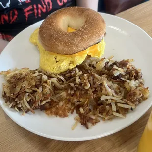 Bagel breakfast sandwich with hash browns.