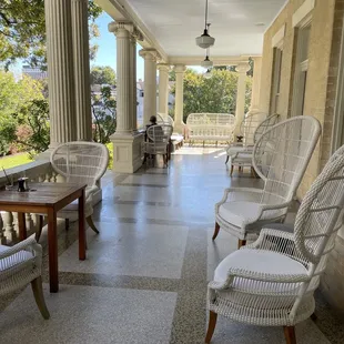 a porch with wicker chairs