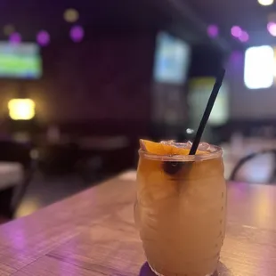 a glass of orange juice on a table