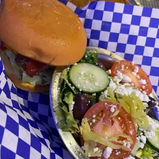 a plate of salad and a hamburger