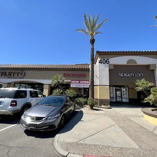 two cars parked in front of the store