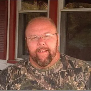 a man with a beard and glasses