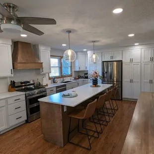 White cabinets with a wood tone island.