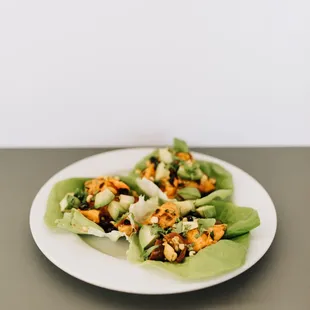 that's my yam tacos: sweet potato, black bean, bell pepper, corn, cilantro, tomato, lime dressing, avocado, butter lettuce