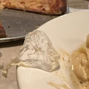 Plastic I pulled out of my mouth while eating the chicken parm with fettuccine Alfredo.