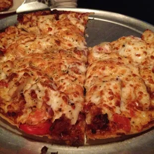Spicy chicken bacon Alfredo pizza (thin crust with chicken, Alfredo, jalapeño, bacon, red pepper, tomatoes and onion). 8 of 10