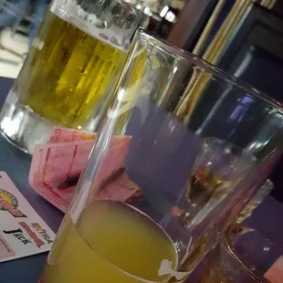 two glasses of beer and a menu