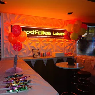 a neon sign and balloons