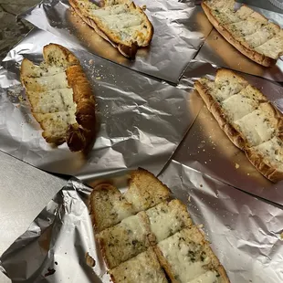 Yummy garlic bread in buttery seasoned garlic sauce on a long hard roll.