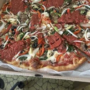 View of pizza to show huge scoops of sauce on it