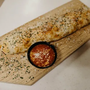 two breadsticks on a cutting board
