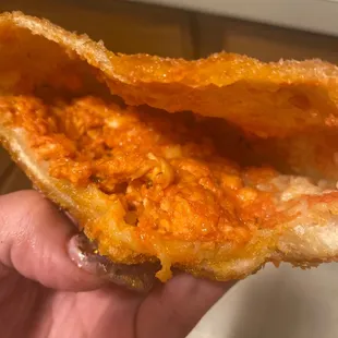 a hand holding a piece of bread