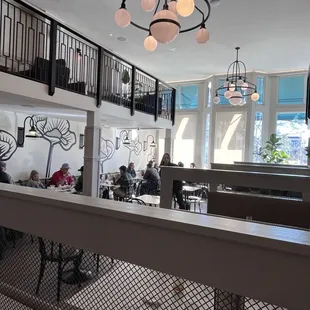 a view of a dining area with people sitting at tables