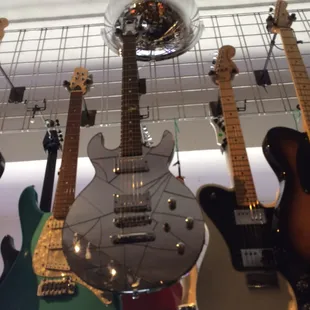 Really nice collection of guitars - this one in the middle looks like shards of mirror were pasted all over it