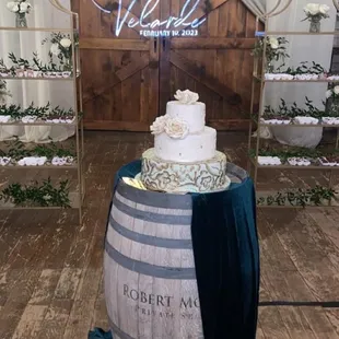 3-tier wedding cake and shelves with desserts