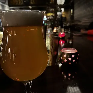 a glass of beer sitting on a table