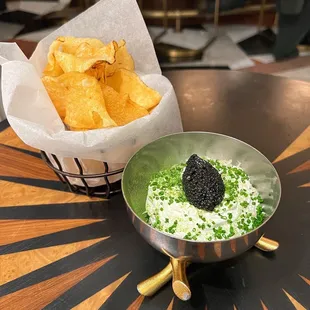 a bowl of chips and a bowl of dip