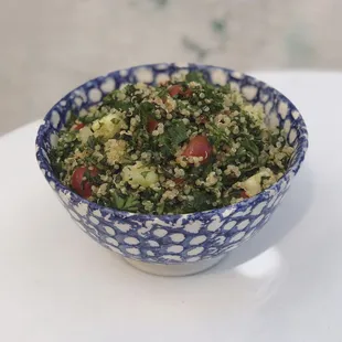 a blue and white bowl of food