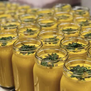 a table full of jars of soup