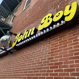 a disco ball hanging from the side of a brick building