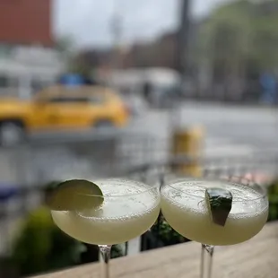 two glasses of cocktail on a table