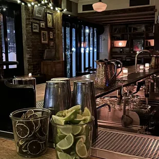 a view of a bar with two glasses of water and lime slices