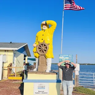 a man standing in front of a statue