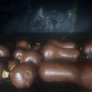 a bunch of sausages cooking in an oven