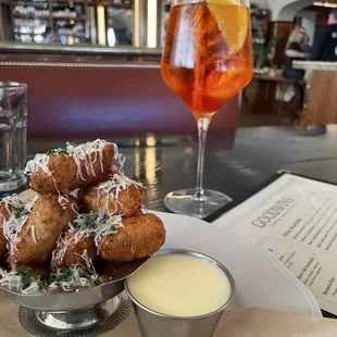 Cheese beignets and aperol spritz