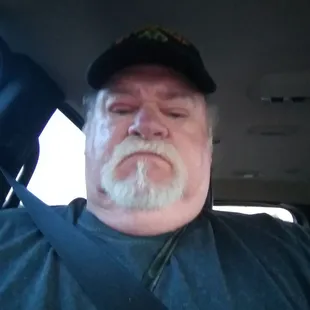 a man sitting in the back seat of a car