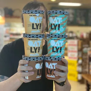 a man holding a stack of ice cream