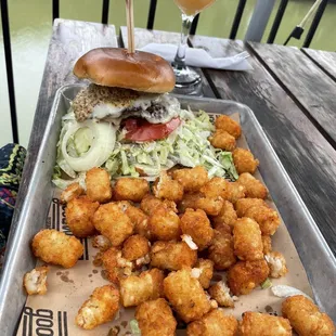 a tray of fried tater tots and a glass of beer