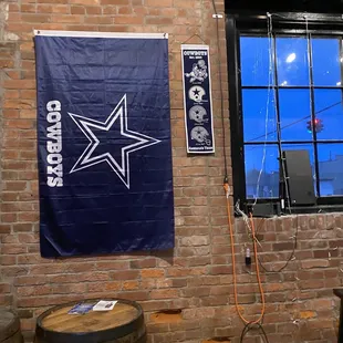 a brick wall with a window and a banner on it