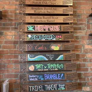 a brick wall with a bunch of signs on it