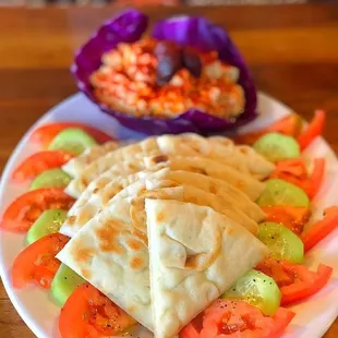 a plate of pita and vegetables