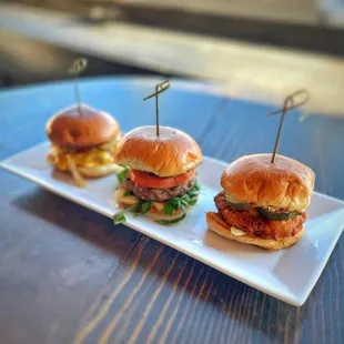 three mini burgers on a plate