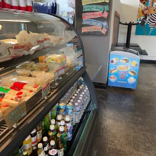 a refrigerated deli case filled with drinks