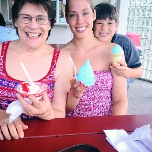 Enjoying  a cherry dip, pistachio flavor, and blue ice cream.