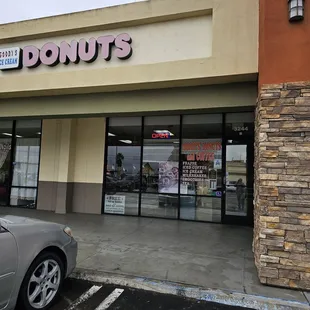 a car parked in front of a donut shop