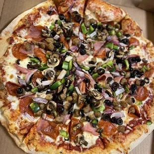 Deluxe pizza with plenty of sausage and pepperoni. The mushrooms, green onions, and purple onions were FRESH!