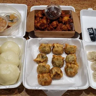 Pickled daikon, 10piece Korean fried chicken, steamed red bean bun, deep fried leek dumpling, steamed xia long bao (top left 2 bottom right)