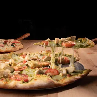 two pizzas on a table